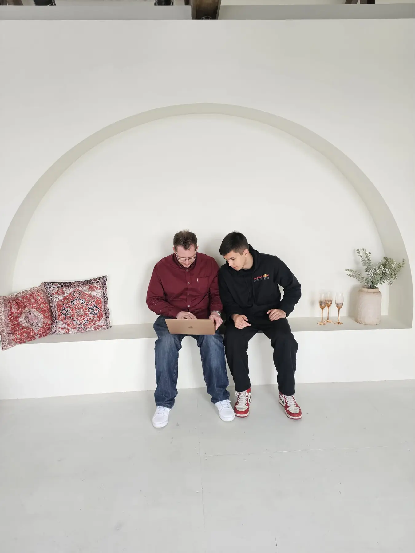 Two community members learning together on a laptop